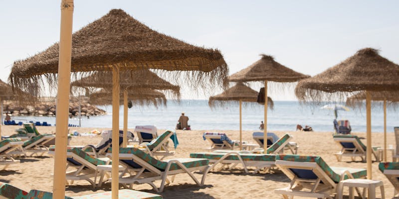 Sun loungers and umbrellas on a tropical beach